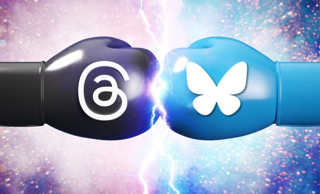 A black boxing glove with the threads logo strikes a blue boxing glove with the bluesky logo. There are sparks of lightning in the center from the impact, and the background is galaxy like.