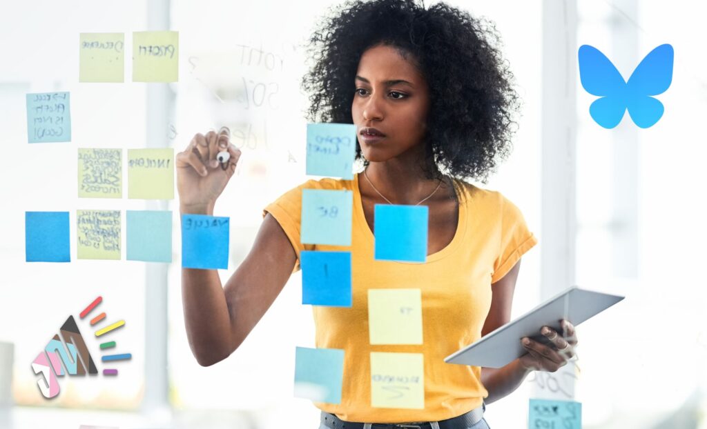 A person is working on a business strategy on a glass wall with post-it notes. The Just Marketing logo and the Bluesky logo are both present.