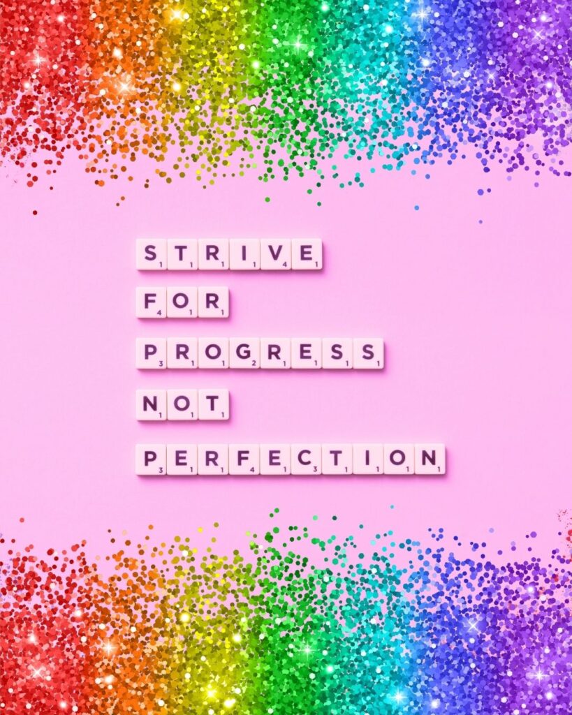 "Strive for progress, not perfection" is written in scrabble tiles on a light pink background. Rainbow glitter borders at the top and bottom.